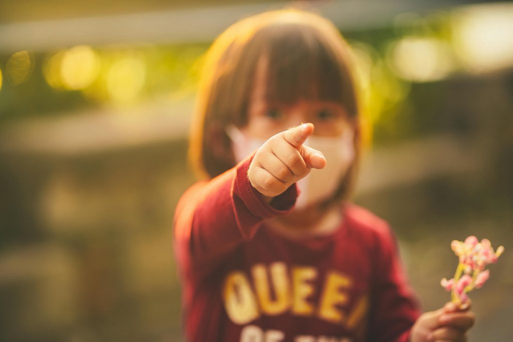Small girl pointing directly at the camera