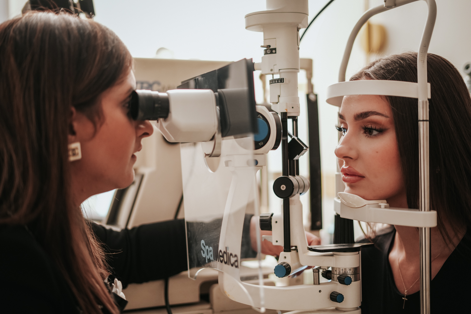 Female patient at Edwards & Walker Opticians in Doncaster have her eyes tested by Dr Pretty Basra.