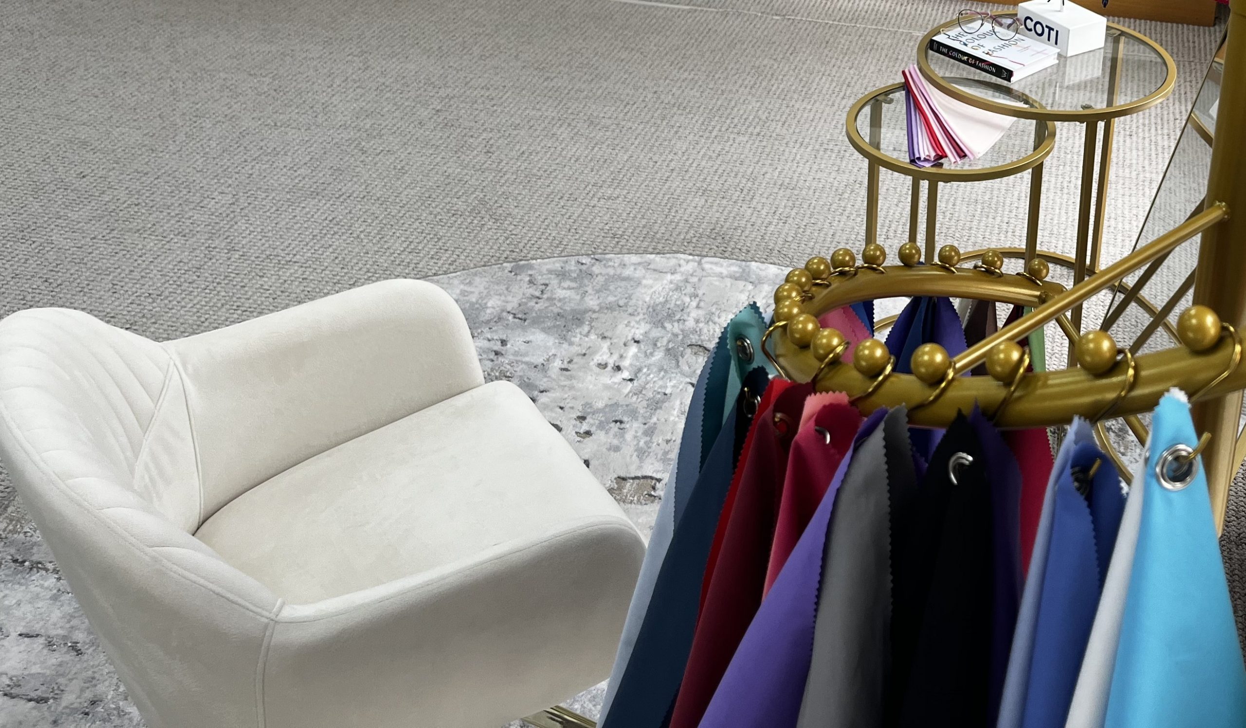 Colour analysis and eyewear styling area at Edwards & Walker Opticians in Doncaster, featuring seasonal colour drapes, a cream styling chair and colour swatches prepared for a personalised glasses styling consultation.