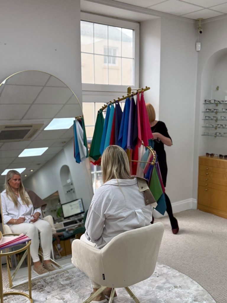 Patient undergoing a personalised colour analysis consultation at Edwards & Walker Optician in Doncaster, using seasonal colour drapes to identify the most flattering colours for eyewear.