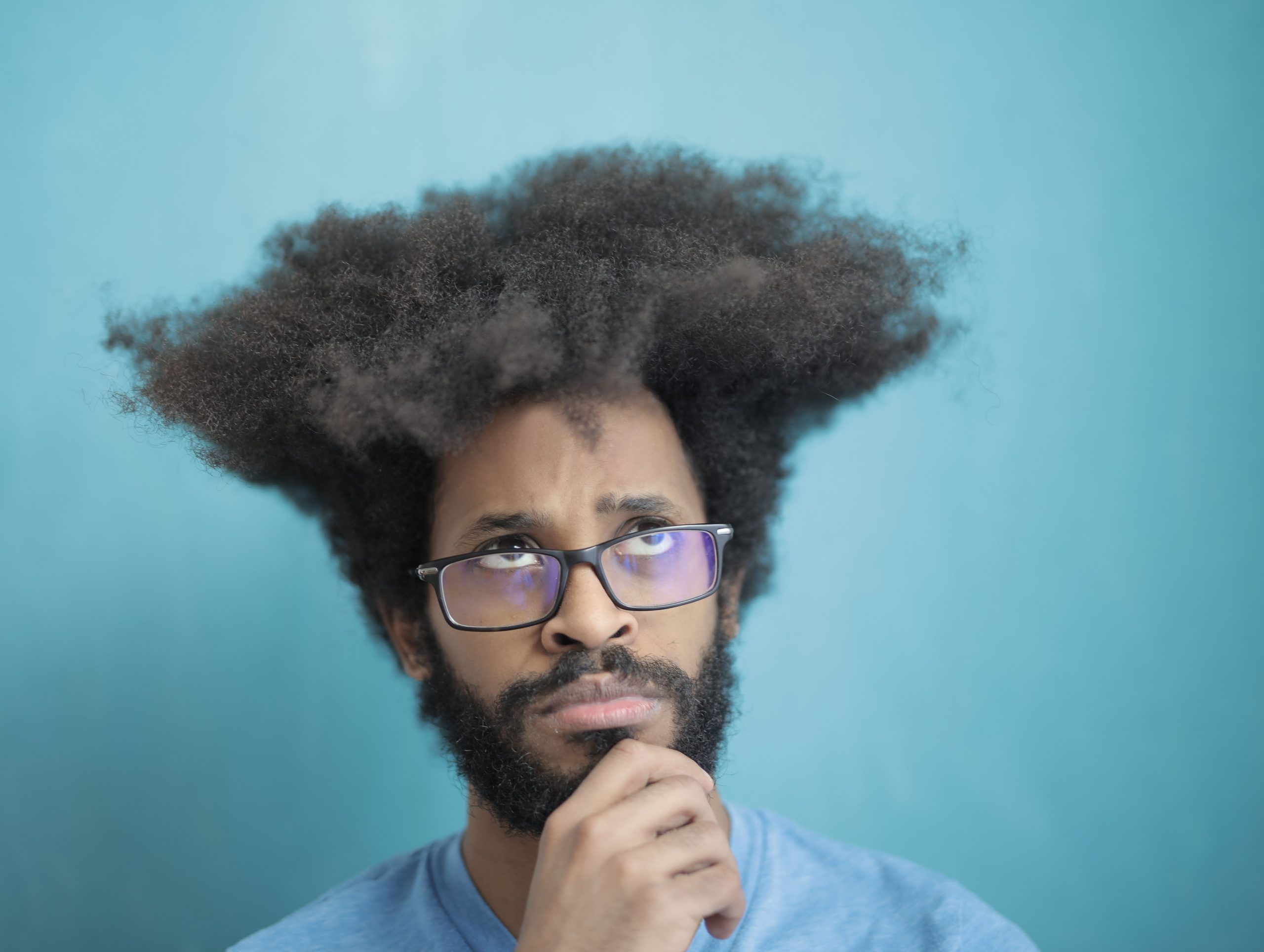 Male wearing glasses looking up to the sky